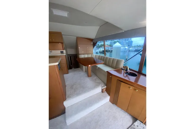Slide: The Image of Luxurious interior of a 2002 Ocean Yacht Super Sport with plush seating and elegant wood finishes. - 4