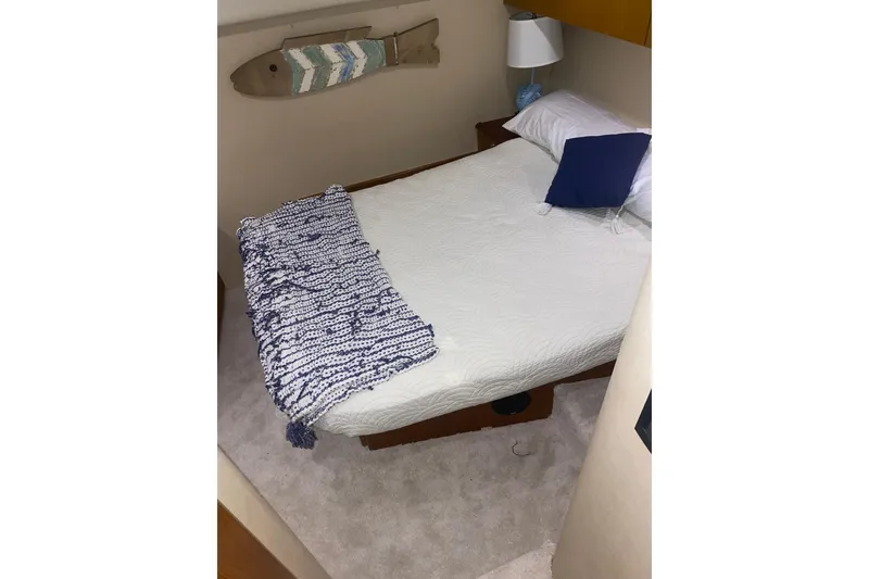 Slide: The Image of Cozy bedroom in 2002 Ocean Yacht Super Sport with nautical decor and plush bedding. - 7