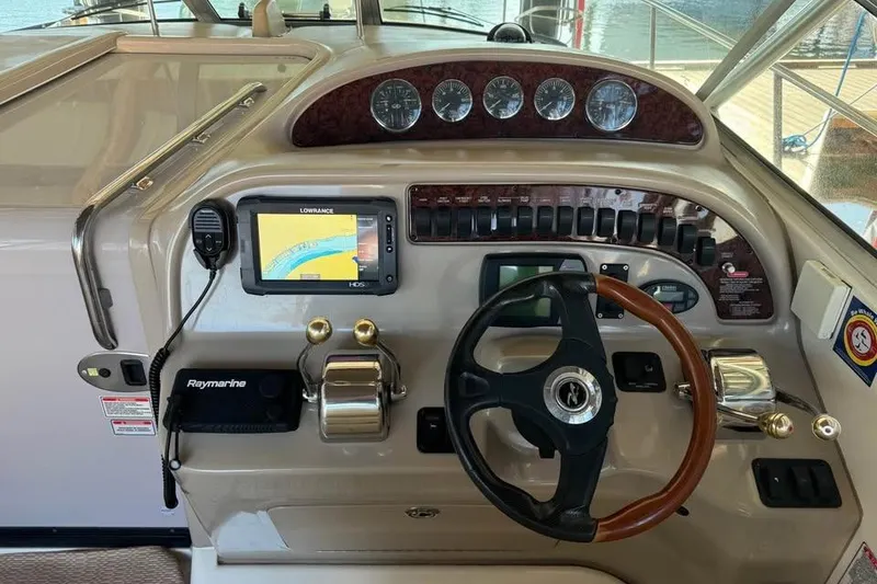 Slide: The Image of 2003 Sea Ray 290 Amberjack helm with navigation equipment and steering wheel. - 10