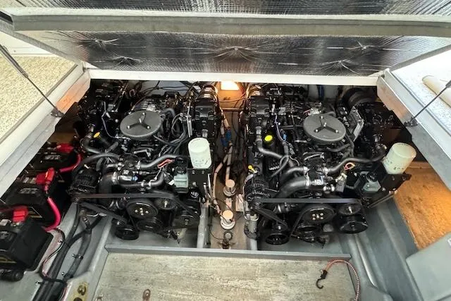 Slide: The Image of Engine compartment of a 2003 Sea Ray 290 Amberjack boat, showcasing dual engines. - 19