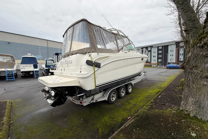 Slide: The Image of 2004 Sea Ray 290 Amberjack boat on trailer in parking lot, overcast day. - 2