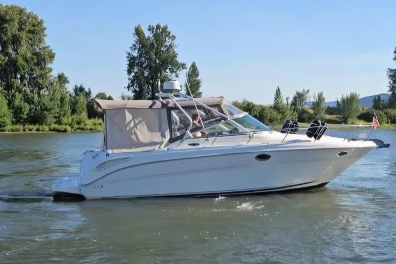 Slide: The Image of 2003 Sea Ray 290 Amberjack cruising on a scenic river. - 22