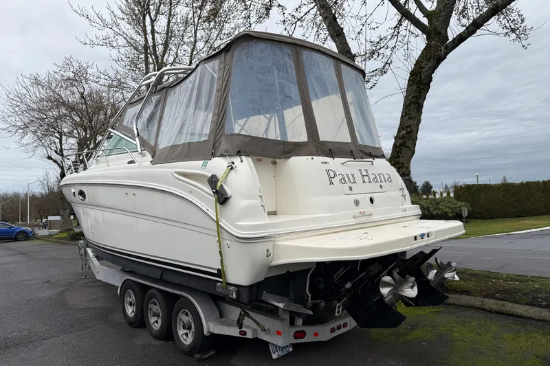 Slide: The Image of 2004 Sea Ray 290 Amberjack boat on trailer, parked outdoors, overcast sky. - 25