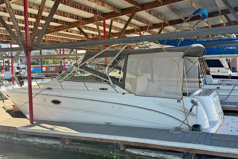 Slide: The Image of 2003 Sea Ray 290 Amberjack boat docked under a covered marina. - 3