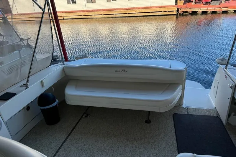 Slide: The Image of 2003 Sea Ray 290 Amberjack boat interior with seating by the water. - 9