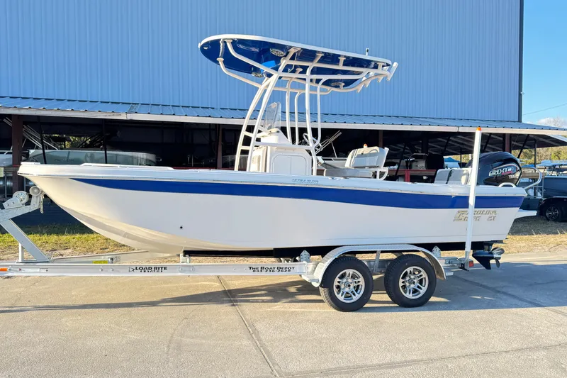The Image of 2026 Carolina Skiff 21 Ultra Elite boat on trailer, parked outdoors. - 1