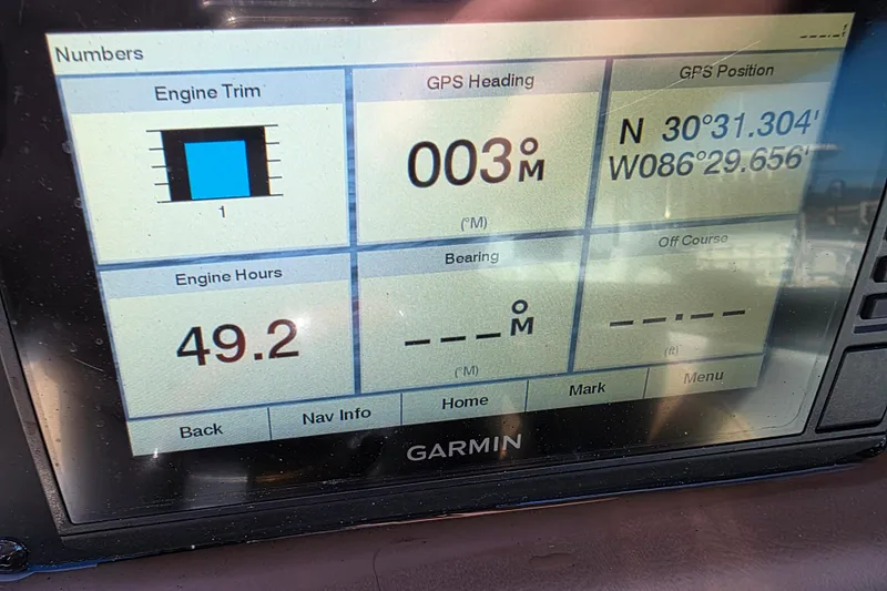 Slide: The Image of Garmin display on 2022 Crownline 264 CR showing engine trim, GPS, and engine hours. - 14