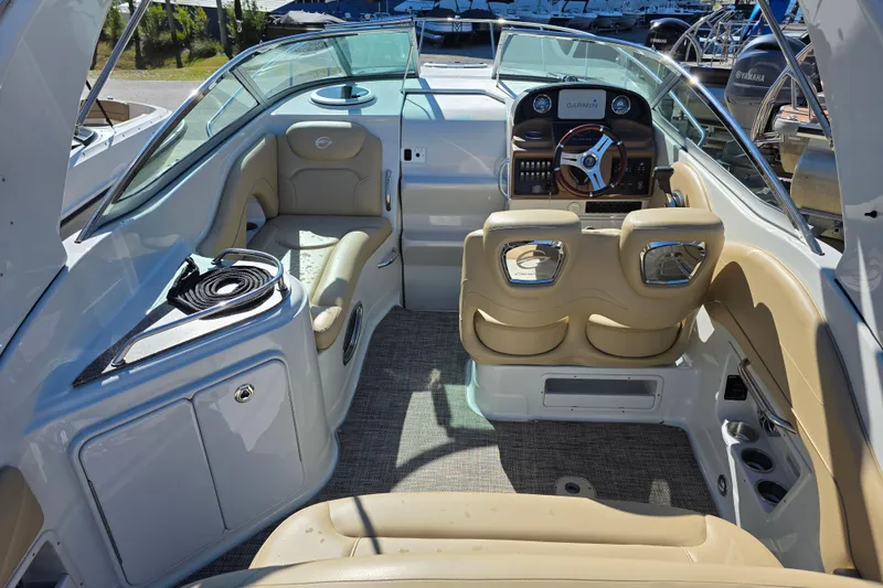 Slide: The Image of 2022 Crownline 264 CR boat interior with beige seating and modern dashboard. - 5