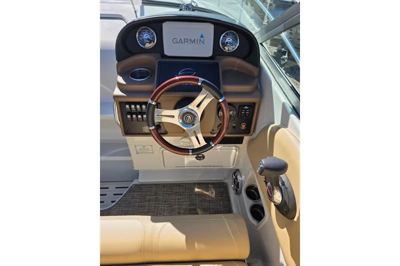 Slide: The Image of 2022 Crownline 264 CR boat helm with Garmin display and leather steering wheel. - 7