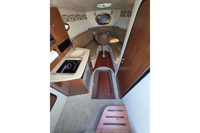 Slide: The Image of Interior of 2022 Crownline 264 CR boat with kitchenette and seating area. - 8