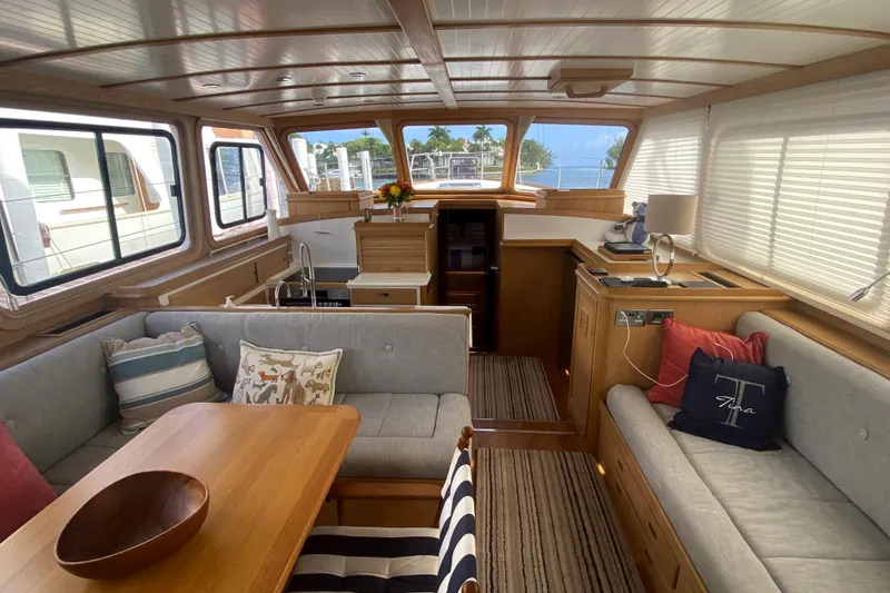 Slide: The Image of Luxurious 1994 Lyman-Morse cruising yacht interior with elegant wood finish and cozy seating. - 1