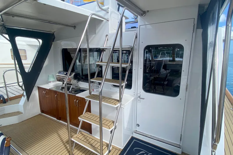 Slide: The Image of 1994 Lyman-Morse Cruising Yacht interior with stairs, wooden cabinets, and sleek design. - 10