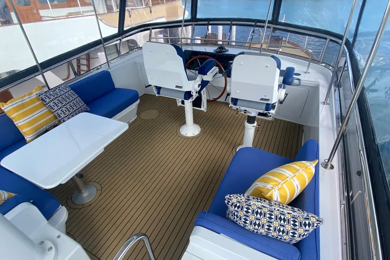 Slide: The Image of Luxurious 1994 Lyman-Morse Cruising Yacht interior with blue seating and decorative pillows. - 13