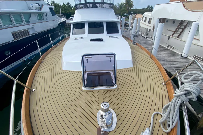 Slide: The Image of 1994 Lyman-Morse Cruising Yacht docked, showcasing teak deck and sleek design. - 15