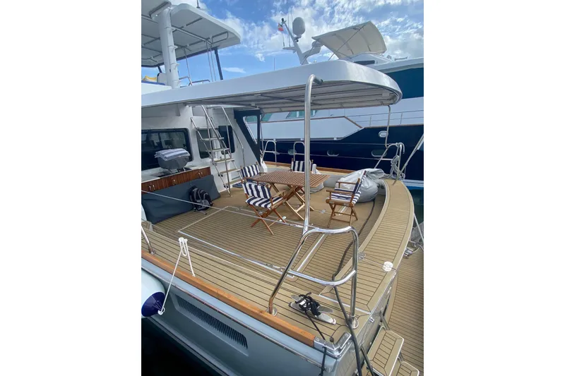 Slide: The Image of 1994 Lyman-Morse Cruising Yacht with spacious deck and seating area. - 16