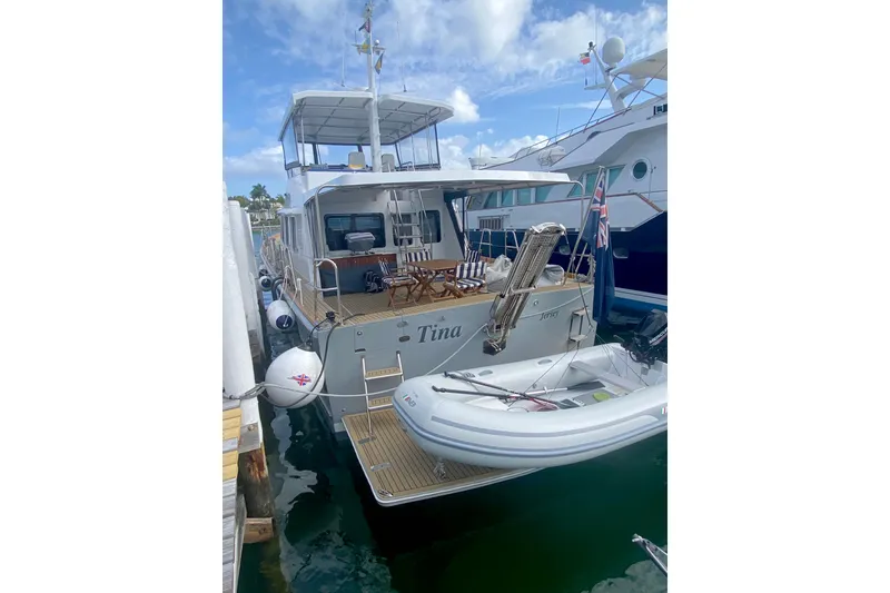 Slide: The Image of 1994 Lyman-Morse Cruising Yacht docked with inflatable boat, clear sky background. - 17