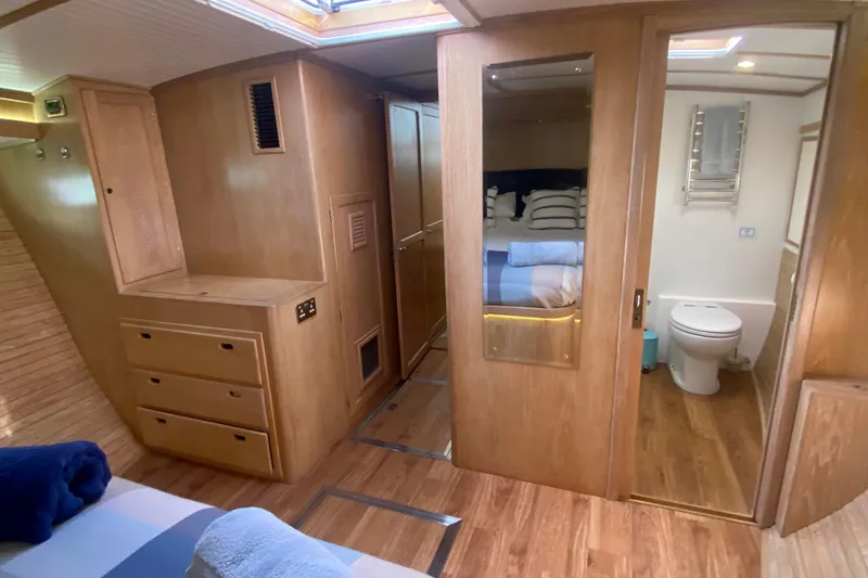 Slide: The Image of Luxurious 1994 Lyman-Morse cruising yacht interior with wood finish, bedroom, and bathroom. - 5