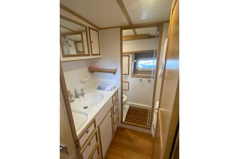 Slide: The Image of 1994 Lyman-Morse Cruising Yacht bathroom with wooden accents and modern fixtures. - 6