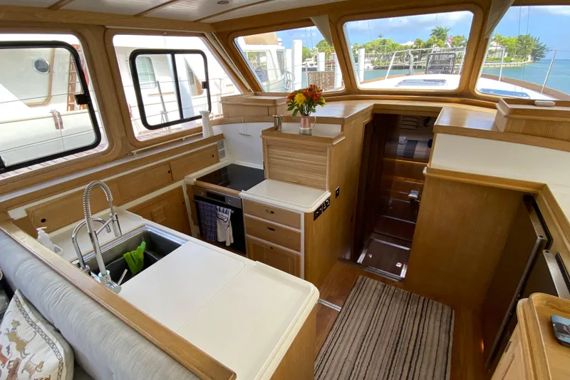 Slide: The Image of Luxurious 1994 Lyman-Morse cruising yacht interior with modern kitchen and scenic windows. - 8