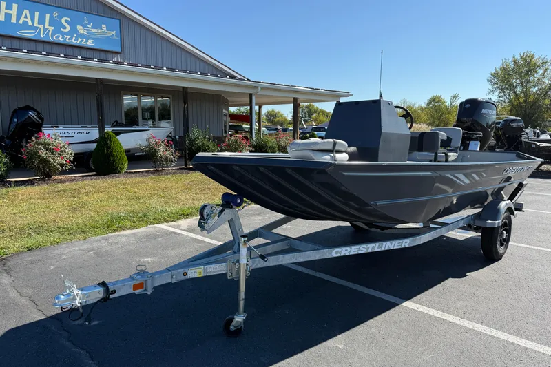 Slide: The Image of 2025 Crestliner 1660 Retriever FCC boat on trailer outside marine shop. - 1
