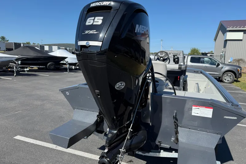 Slide: The Image of 2025 Crestliner 1660 Retriever FCC with Mercury 65 HP engine in a parking lot. - 3
