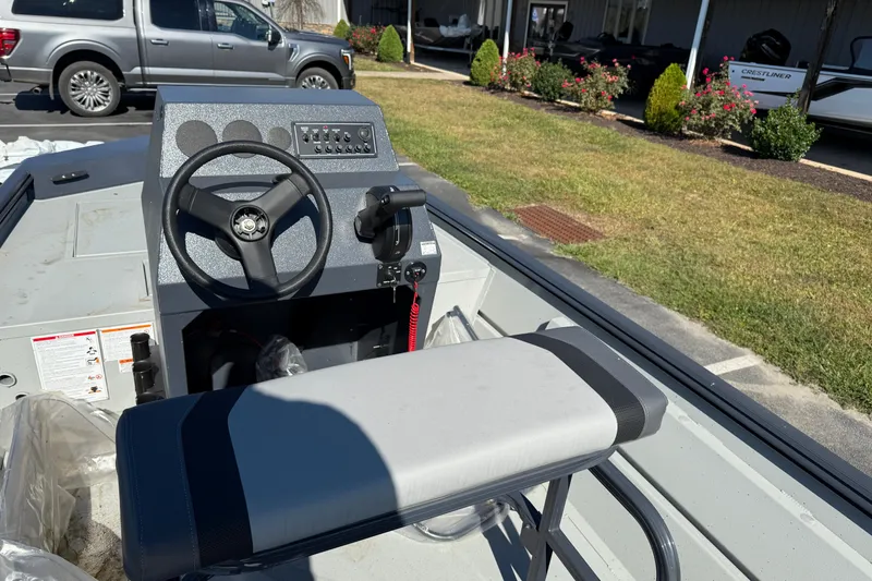 Slide: The Image of 2025 Crestliner 1660 Retriever FCC boat interior with steering wheel and control panel. - 5