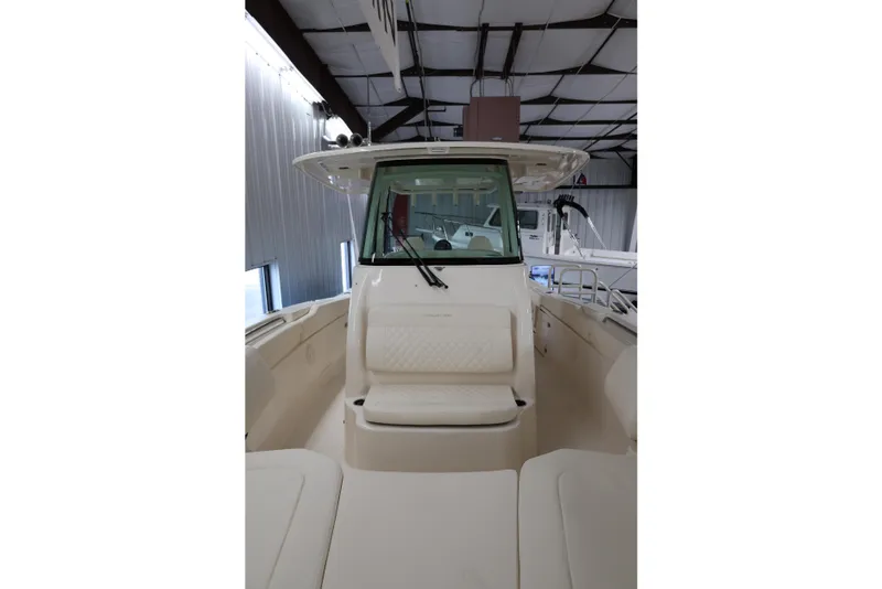 Slide: The Image of 2026 Grady-White Canyon 306 boat interior, featuring seating and helm in a spacious cabin. - 11
