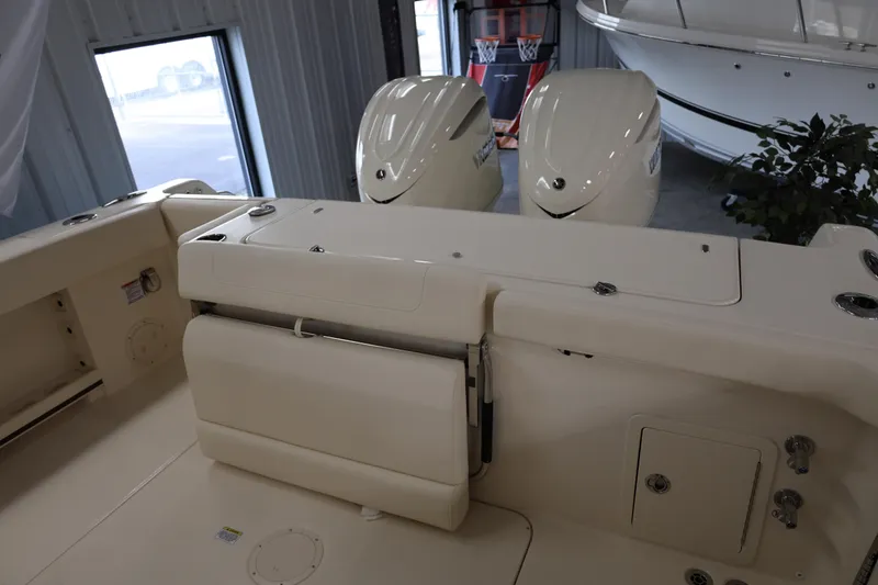 Slide: The Image of 2026 Grady-White Canyon 306 boat interior with dual outboard motors in showroom. - 5