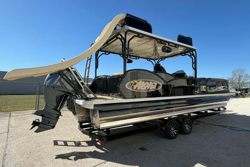 Slide: The Image of 2026 Aloha Paradise 300 Sundeck boat with slide and dual engines on trailer. - 11