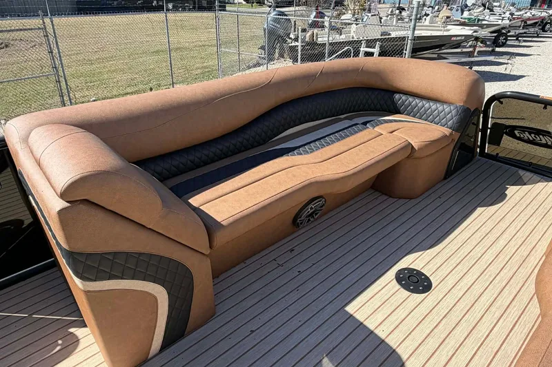 Slide: The Image of Luxurious seating on 2026 Aloha Paradise 300 Sundeck boat, featuring elegant brown and black upholstery. - 17