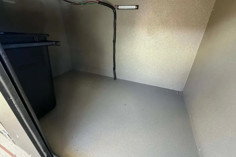 Slide: The Image of Storage compartment of 2026 Aloha Paradise 300 Sundeck boat, featuring wiring and spacious interior. - 18