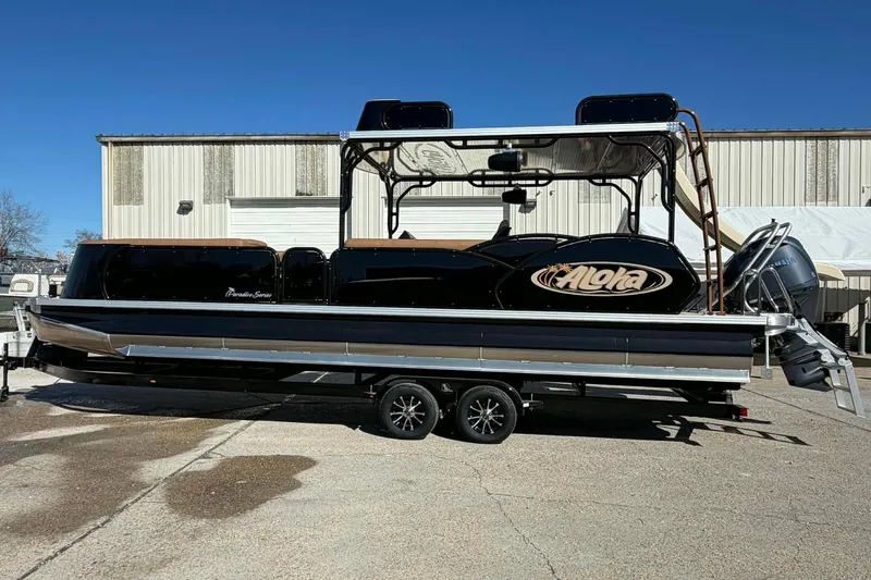 Slide: The Image of 2026 Aloha Paradise 300 Sundeck boat on trailer, parked outdoors. - 19