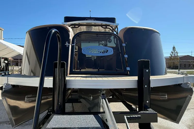 Slide: The Image of 2026 Aloha Paradise 300 Sundeck pontoon boat on display under clear blue sky. - 22