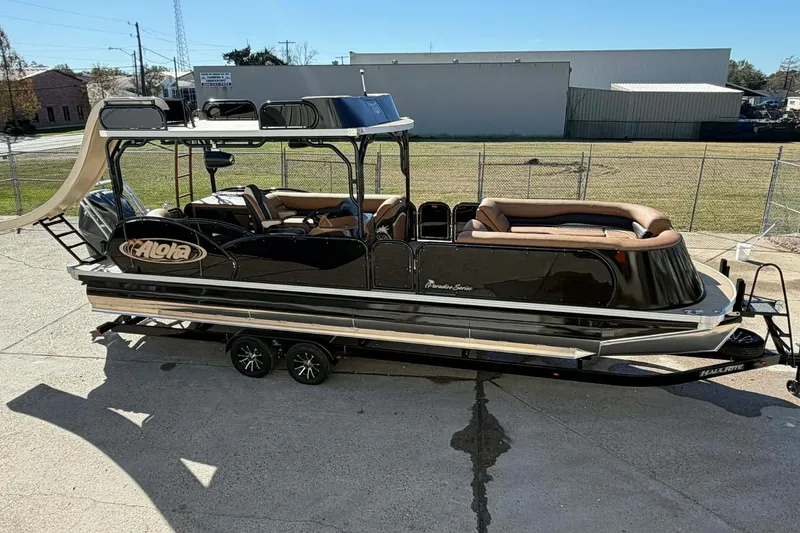 Slide: The Image of 2026 Aloha Paradise 300 Sundeck boat with slide, parked on a trailer. - 24