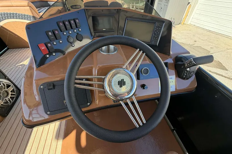 Slide: The Image of Steering console of 2026 Aloha Paradise 300 Sundeck with controls and display screens. - 25