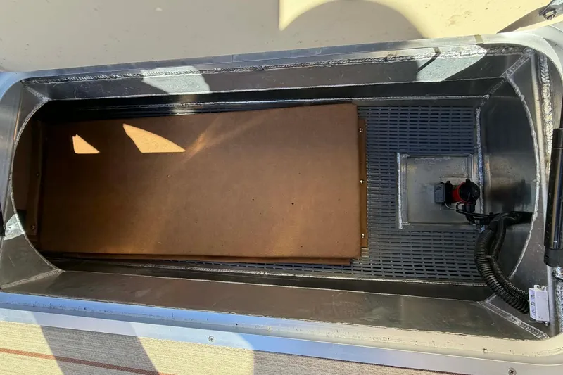 Slide: The Image of Storage compartment of 2026 Aloha Paradise 300 Sundeck boat, featuring durable materials and wiring. - 26