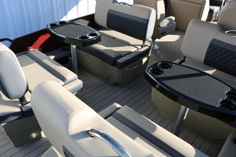 Slide: The Image of Luxurious seating area on 2026 Sylvan L3 RLZ boat with modern tables and cup holders. - 23
