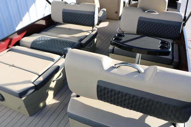 Slide: The Image of 2026 Sylvan L3 RLZ boat interior with beige seating and a black table. - 25