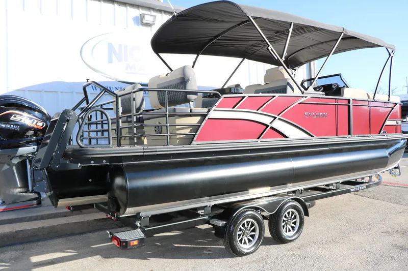 Slide: The Image of 2026 Sylvan L3 RLZ pontoon boat with red exterior and black canopy on trailer. - 5