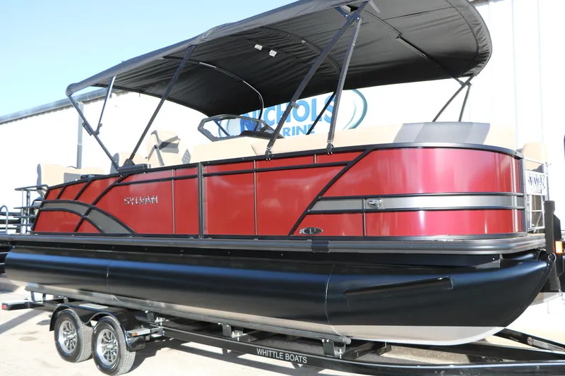 Slide: The Image of 2026 Sylvan L3 RLZ pontoon boat with red exterior and black canopy on trailer. - 8