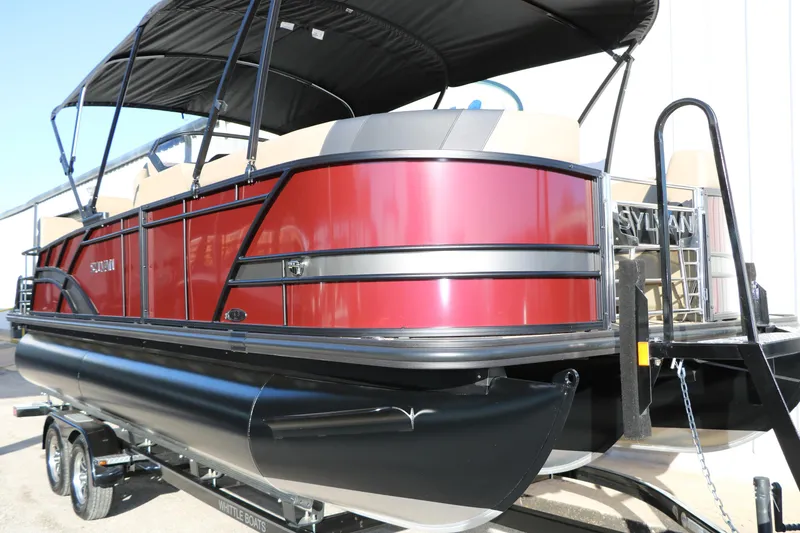 Slide: The Image of 2026 Sylvan L3 RLZ pontoon boat with red exterior and black canopy on trailer. - 9