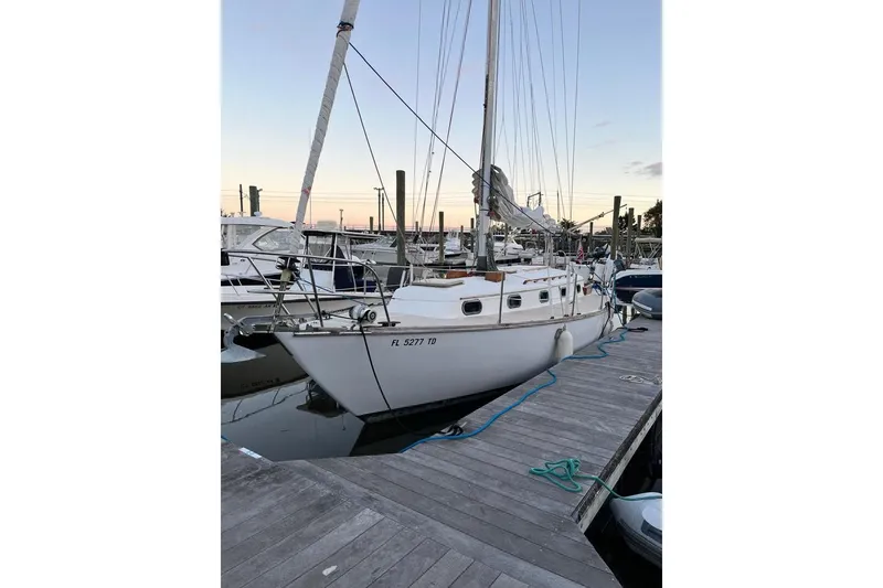 The Image of 1981 Cape Dory 33 sailboat docked at marina during sunset. - 0