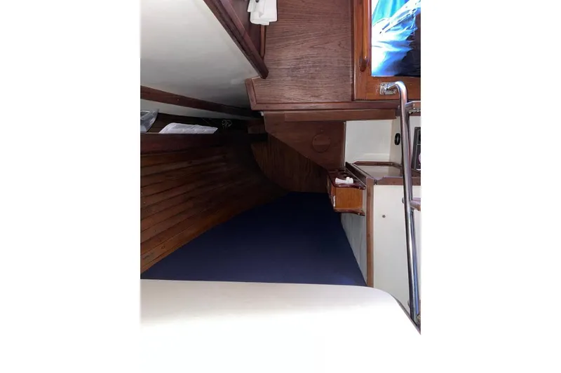 Slide: The Image of Interior cabin of 1981 Cape Dory 33 sailboat with wooden finish and blue bedding. - 10