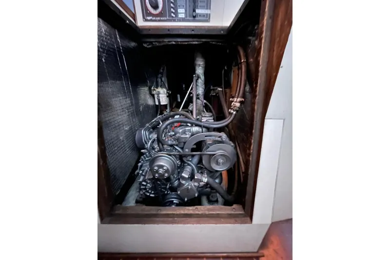 Slide: The Image of Engine compartment of a 1981 Cape Dory 33 sailboat, showcasing mechanical components. - 14