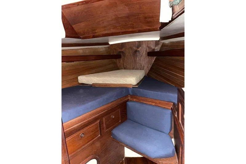 Slide: The Image of Interior cabin of 1981 Cape Dory 33 sailboat with wooden finish and blue cushions. - 7
