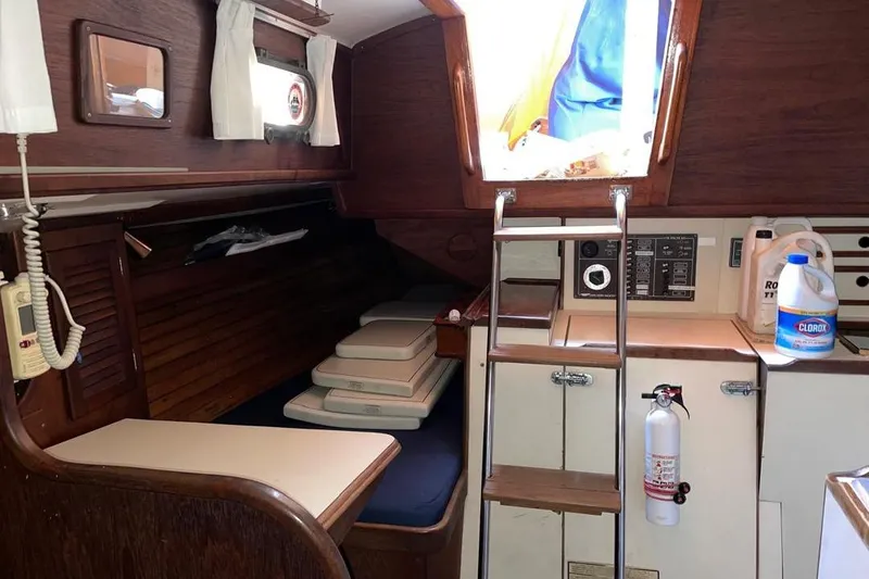 Slide: The Image of Interior of a 1981 Cape Dory 33 sailboat with wooden finishes and ladder access. - 8