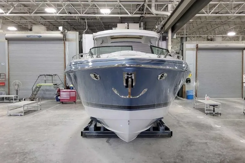 Slide: The Image of 2023 Formula 350 Crossover Bowrider I/O in a warehouse, front view. - 1