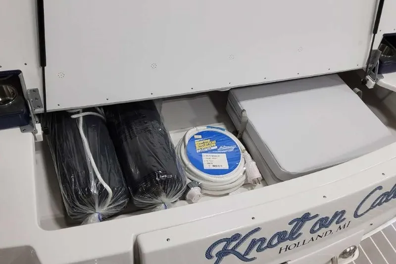 Slide: The Image of 2023 Formula 350 Crossover Bowrider I/O storage compartment with boating accessories. - 14