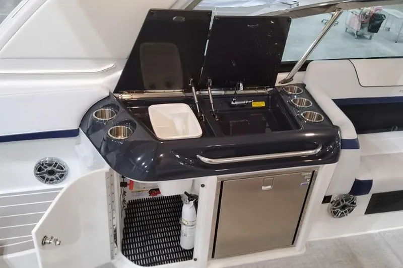 Slide: The Image of 2023 Formula 350 Crossover Bowrider I/O boat interior with kitchenette and stainless steel features. - 21