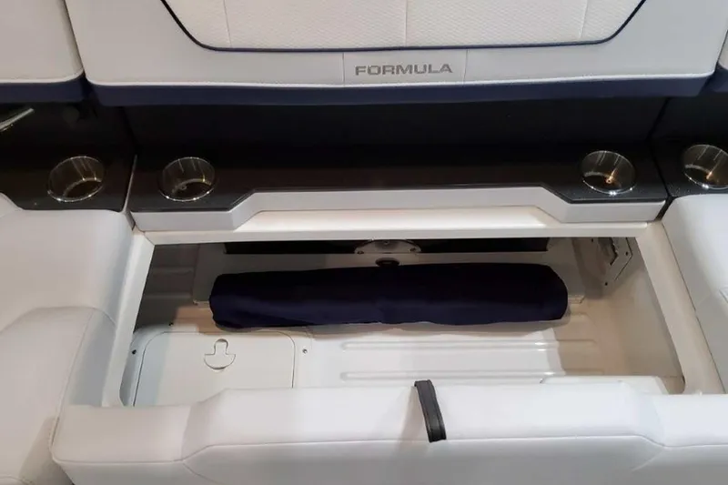 Slide: The Image of 2023 Formula 350 Crossover Bowrider I/O interior storage compartment with cup holders. - 27